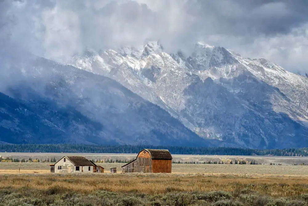 Dark clouds over Mormon Row in Grand Teton National Park Wyoming during autumn. The best photography spot Grand Teton National Park