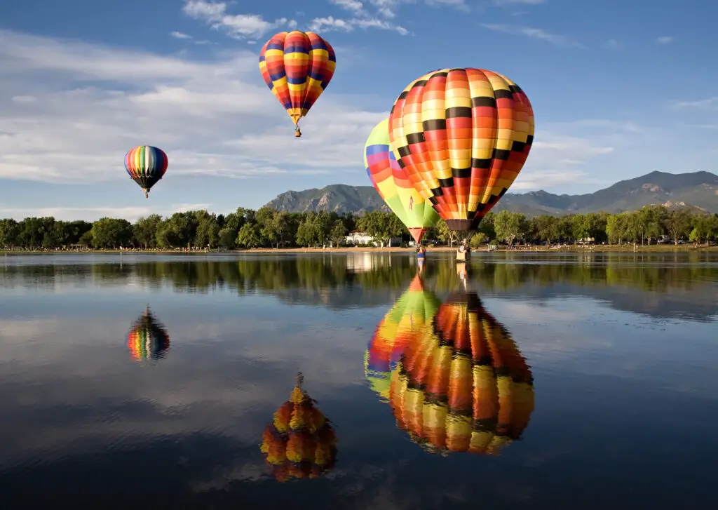 Hot air balloons touch down in Prospect Lake during the Colorado Springs Balloon Classic s mass ascension.