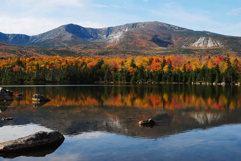 Vivid saturated fall colors at Sandy Stream Pond with the North Basin as a back drop. Baxter State Park Maine. Best Photography spot in Maine