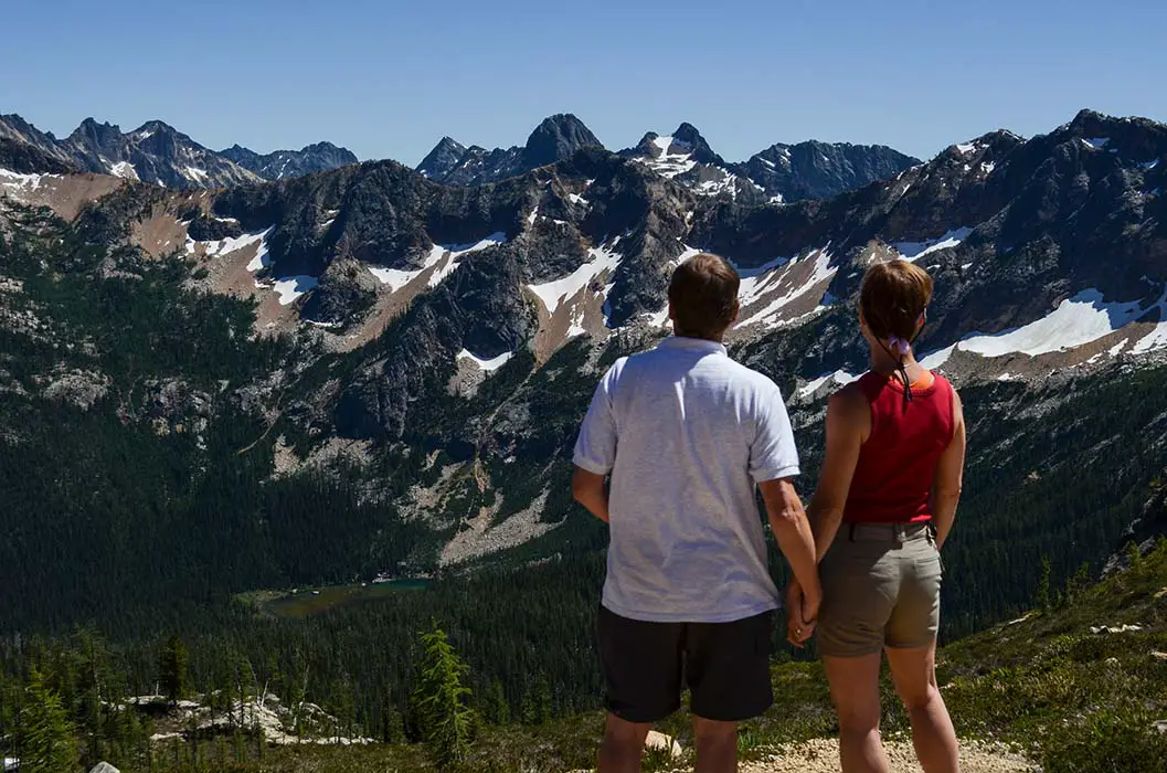 A couple enjoy the view from Cutthroat Pass Trail. The best Photography spots in North Cascade National Park