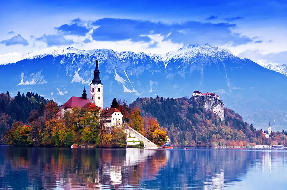 Bled with lake island castle and mountains in background. The best Photography spots in Slovenia