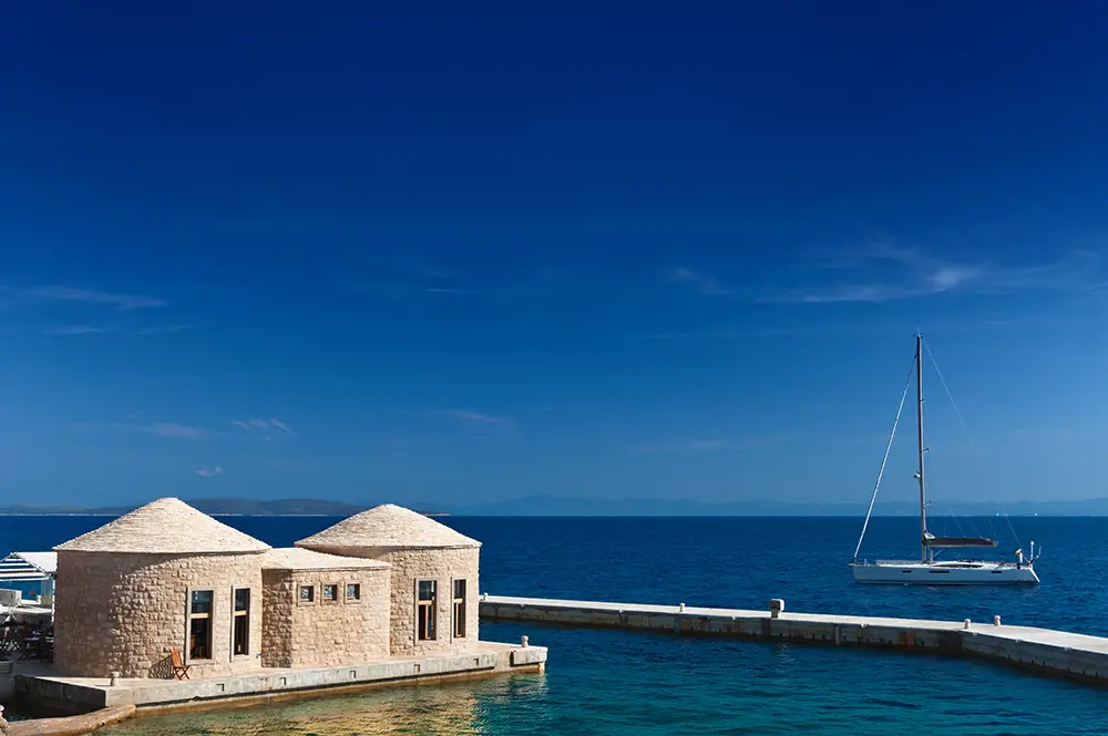 Hvar island Scenic view with yacht and typical Dalmatian styled stoned huts bunja. The best Photography spots in Croatia