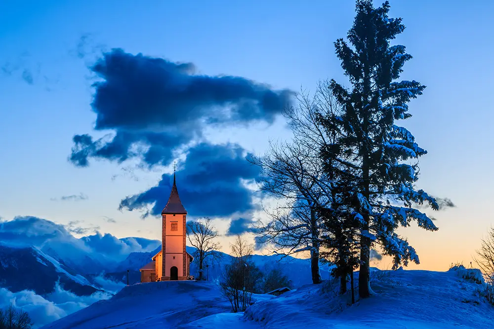 St. Primoza church near Jamnik at dawn in winter. The best Photography spots in Slovenia