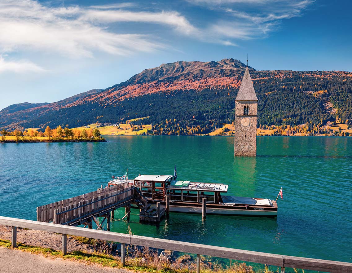 Adorable autumn view of Tower of sunken church in Resia lake. Best Natural Wonders in Italy