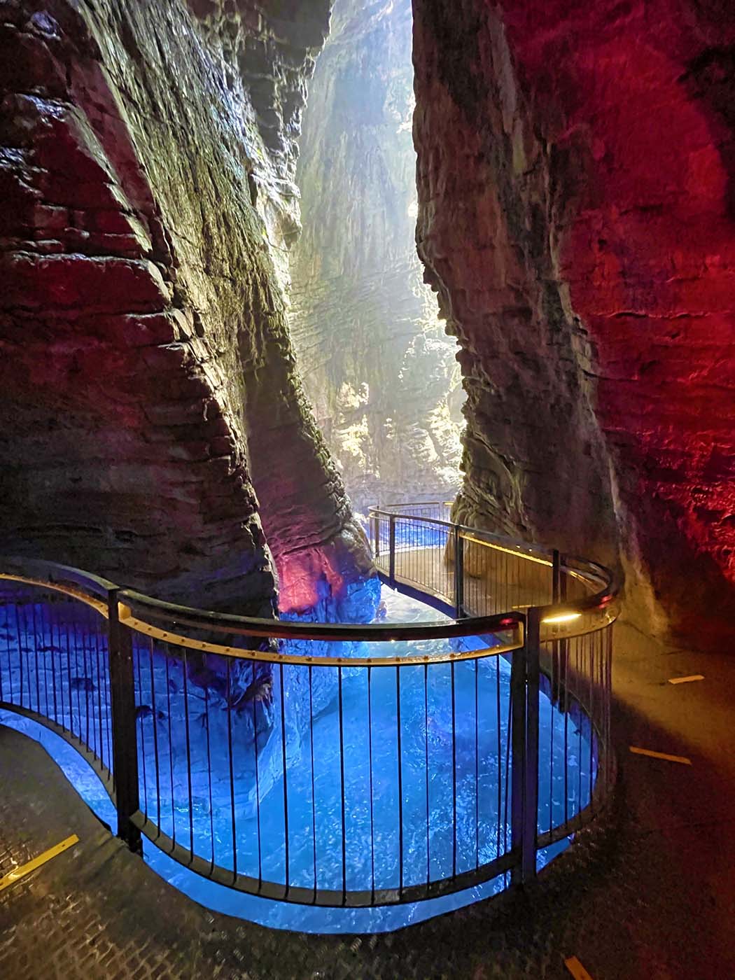waterfall in cave with colored lights cascate del varone. Best Photography spots in Lake Garda